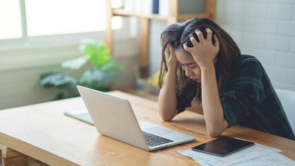 Asian women are working at home using their laptop...Work with stress