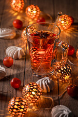 Spicy winter tea or punch with anise and meringue pastry