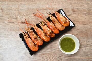 grilled river shrimp arranging on plate dipping spicy sauce