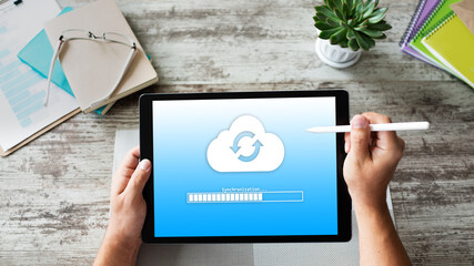 Cloud synchronization progress bar on tablet screen. Data storage and protection. Technology and...