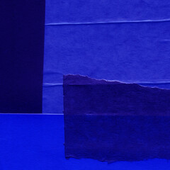 Blue and violet torn paper collage close-up. Texture made from various paper and cardboard parts....