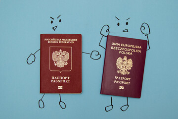 Russian passport and Polish passport with drawn faces and hands arguing among themselves