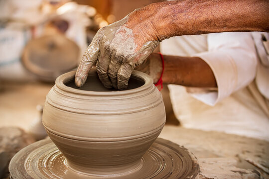 Potter at work makes ceramic dishes. India, Rajasthan.