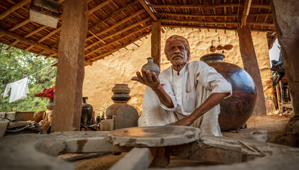 Potter at work makes ceramic dishes. India, Rajasthan.