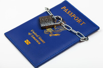 American passport with a chain locked on a padlock on a white background