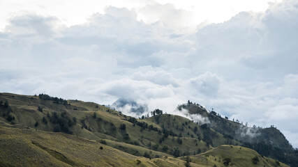 landscape with clouds, panorama of the mountains in the morning, sunrise over the hills and mountains with fluffy clouds, Lombok Island, Indonesia