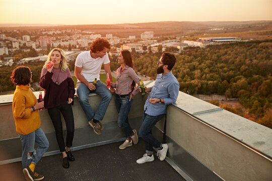 Group Of Friends With Drinks Having Party On Rooftop