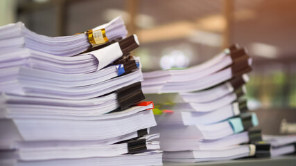 Unfinished Report of papers document folder with black clippaper. Pile a lot of agreements report sheet prepareing signature or approval from administrator check in important page on desk in office