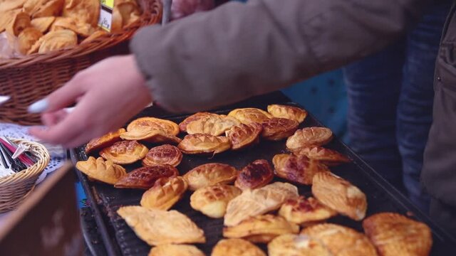 Making polish grilled and smoked cheese, oscypek in the Christmas fair in Katowice, Poland.