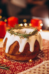 Christmas stollen: holiday pie decorated with rosemary and Christmas decor on the table. Сoncept for postcard, banner, holiday greeting