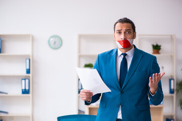 Mouth closed male employee working in the office