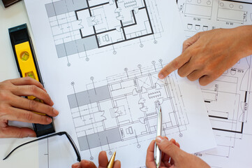 Close up the architect is designing and drawing the structure of the building.