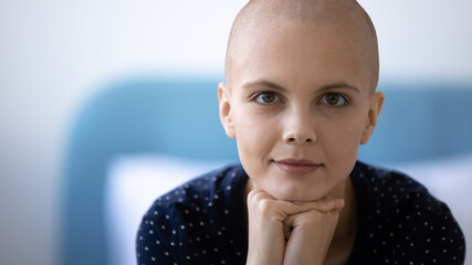 Head shot portrait close up hairless young woman struggling with cancer, oncology disease, strong...