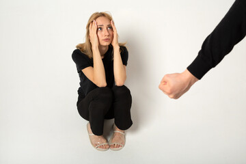 young woman in fear of being hit by a man