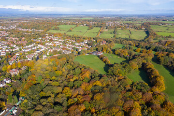 A beautiful aerial photo in the autumn fall at the park in Leeds West Yorkshire known as Roundhay Park showing the brown and green colours on the trees