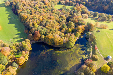 A beautiful aerial photo in the autumn fall at the park in Leeds West Yorkshire known as Roundhay Park showing the brown and green colours on the trees