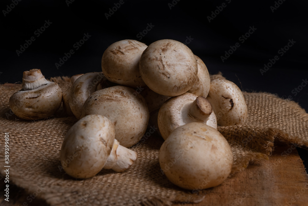 Wall mural Fresh Button Mushroom on wooden table.