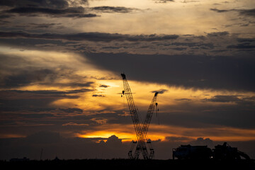 Fototapeta premium Crane Stood Still at the construction site at sunset