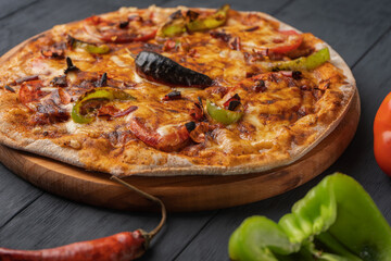 Vegetarian hot chili pizza on a wooden Board, close-up
