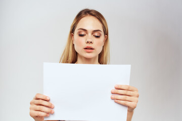 woman holding a sheet of paper in her hands lifestyle striped t-shirt cropped view Copy Space
