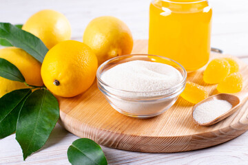 Colorful marmalade candies and gelling agents on wooden cutting board