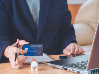 Businessman holding or showing blue creadit card for shopping online. E-commerce, commercial, payment concept.
