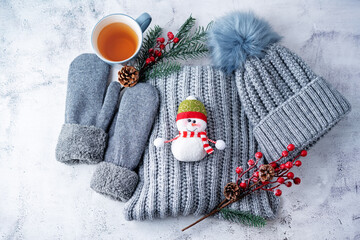 Winter Christmas holidays background with Cup of tea and wool hat, mittens and scarf