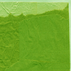 Green torn paper collage close-up. Texture made from various paper and cardboard parts. Damaged old paper background. Vintage blank wallpaper. Material design backdrop.