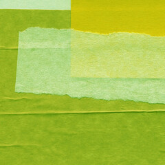 Fototapeta premium Green torn paper collage close-up. Texture made from various paper and cardboard parts. Damaged old paper background. Vintage blank wallpaper. Material design backdrop.