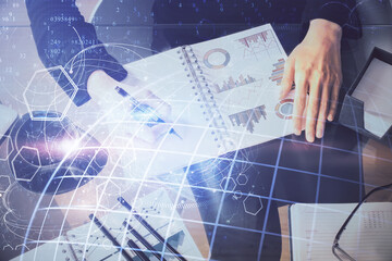 Multi exposure of hands making notes with world map hologram and data theme icons. Concept of global data.