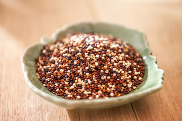 Close-up of quinoa in green leaf shape porcelain dish