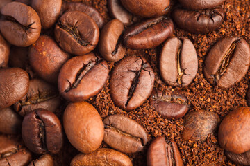 Coffee beans and coffee powder (ground coffee) brown background.