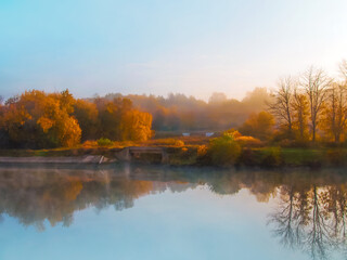 Beautiful forest with autumn foliage on dawn. Autumn landscape, bridges, reflected in the water, soft focus