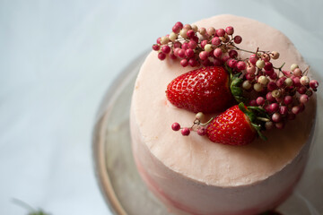 Strawberry, pink special day cake. Close up on white background.