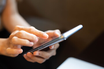 Women are typing messages choose products online,in the coffee cafe.