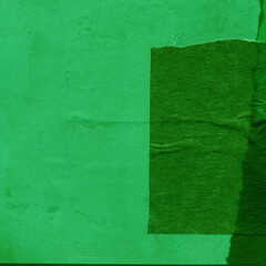 Green torn paper collage close-up. Texture made from various paper and cardboard parts. Damaged old paper background. Vintage blank wallpaper. Material design backdrop.