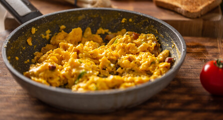 Freshly made scrambled eggs in a cooking pan