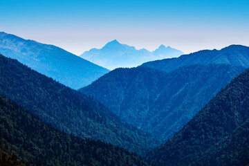 series of mountain ranges to the horizon, blue in the atmospheric haze