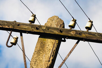 Old style wooden power pole. Power pole with power lines, blue sky