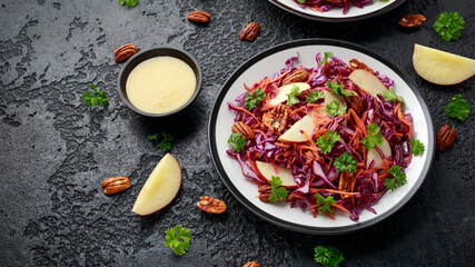 Red Cabbage salad with carrots, apples and pecan nuts. Healthy vegan food