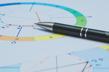 Workplace of a modern astrologer. Printouts of astrological charts, tables, diagrams lying on the table.