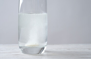 Glass of water and a tablet on the table
