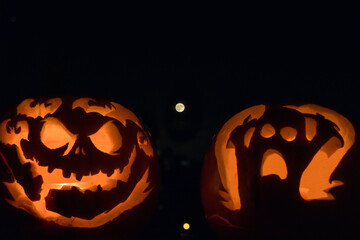 Carved pumpkins with moon rising in the background