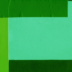 Green torn paper collage close-up. Texture made from various paper and cardboard parts. Damaged old paper background. Vintage blank wallpaper. Material design backdrop.