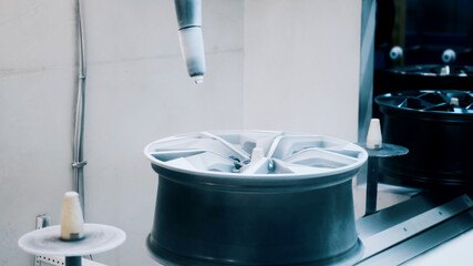 White cast disc on conveyor belt before painting