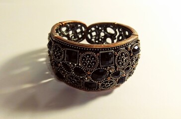 wide bracelet with stones on a light background