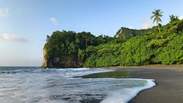 Tropical black sand beach anse levrier Martinique sunset calm shore waves 