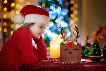 Christmas celebration at home. Girl with Xmas cake