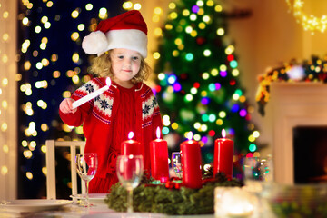 Fototapeta na wymiar Family with kids having Christmas dinner at tree