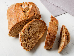 a loaf of sliced bread on a rustic table